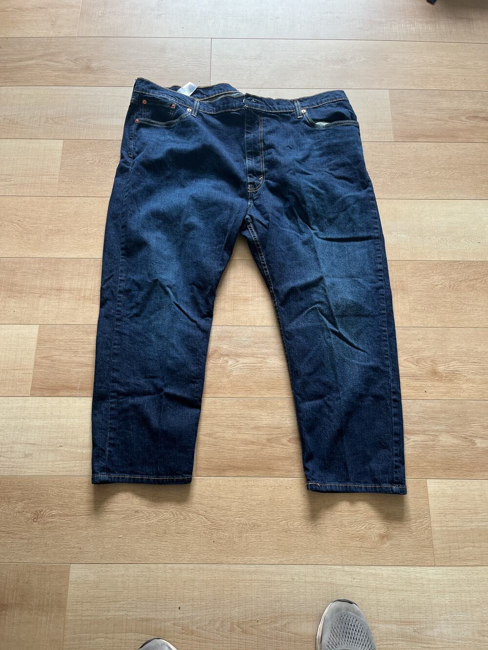 Levi Strauss & Co. 502 dark wash blue denim jeans with five pocket design and bu